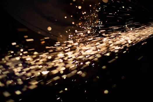Sparks in dark. Metal grinding lights. Details of grinder's work. photo