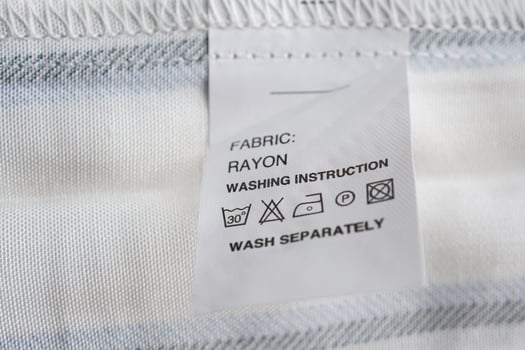 White laundry care washing instructions clothes label on rayon shirt photo