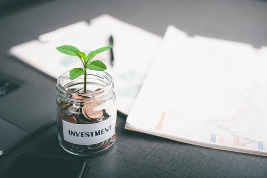Message on paper and coins in glass jar,savings concept. financial growth, business investment and currency exchange, financial asset investment management,Sustainable Profit Increase photo