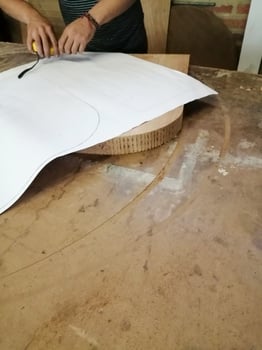 An Anonymous Carpenter Working on New Project at his Workshop. Table top view of unrecognizable man drawing n photo