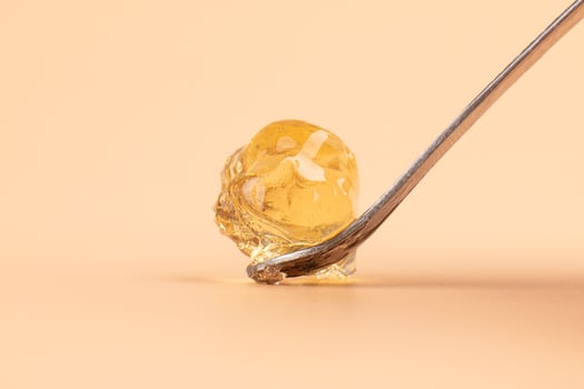yellow wax with dabbing stick of cannabis resin for smoking high in THC photo