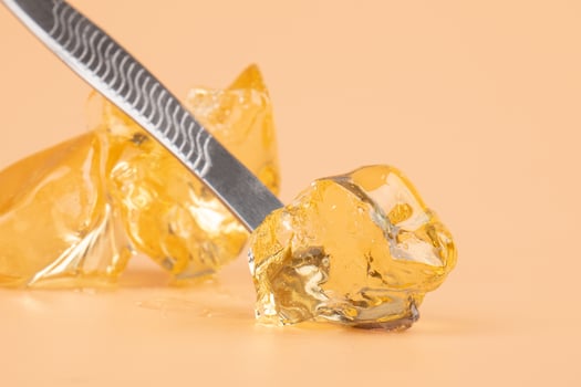 yellow wax with dabbing stick of cannabis resin for smoking high in THC photo