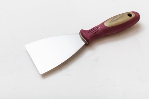 metal spatula with plastic handle on floor photo