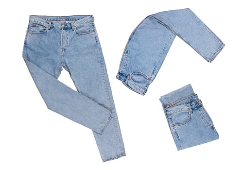 Denim pants - folded, straightened, folded in half isolated on white background photo