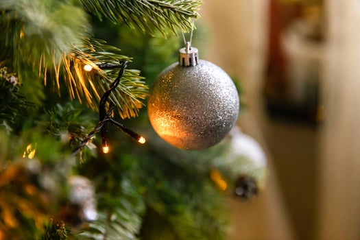 Classic Christmas decorated New year tree. Christmas tree with wite and silver decorations, ornaments toy and ball. Modern classical style interior design apartment. Christmas eve at home. photo