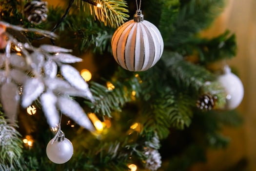 Classic Christmas decorated New year tree. Christmas tree with wite and silver decorations, ornaments toy and ball. Modern classical style interior design apartment. Christmas eve at home. photo