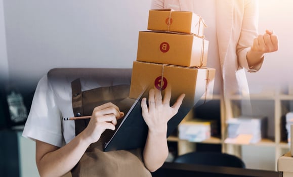 Startup SME small business entrepreneur of freelance Asian woman using a laptop with box Cheerful success Asian woman her hand lifts up online marketing packaging box and delivery SME idea concept photo