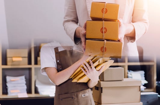 Startup SME small business entrepreneur of freelance Asian woman using a laptop with box Cheerful success Asian woman her hand lifts up online marketing packaging box and delivery SME idea concept photo