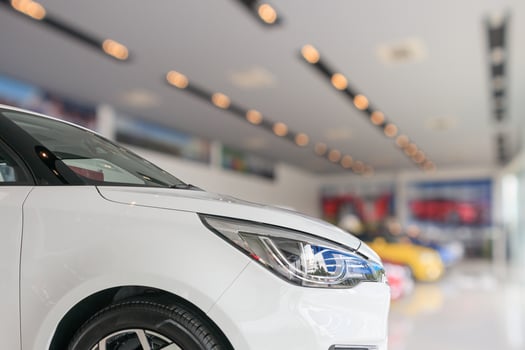 closeup front of new car in showroom background photo