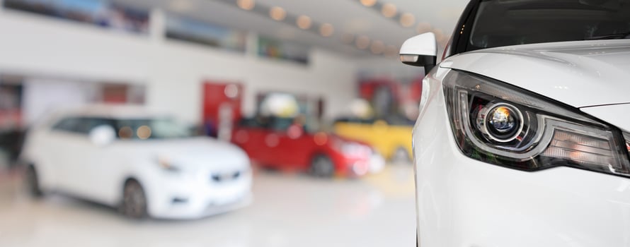 closeup front of new car in showroom background photo