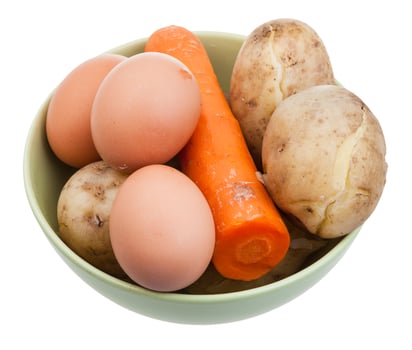 boiled eggs, carrot and potatoes in ceramic bowl photo