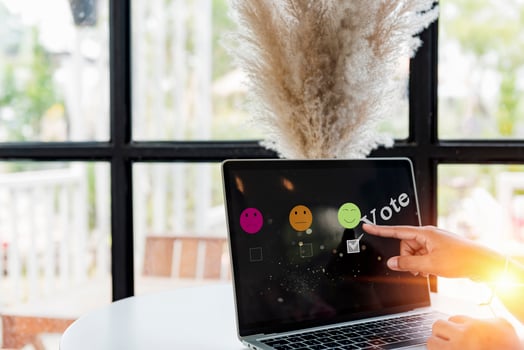 Hand woman use laptop choosing green happy smile face icon. feedback rating and positive customer review experience, satisfaction survey. mental health assessment. world mental health day concept. photo