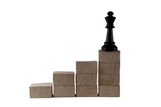 chess pieces on top of a wooden block. the concept of success of a leader photo