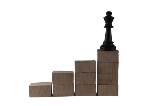 chess pieces on top of a wooden block. the concept of success of a leader photo