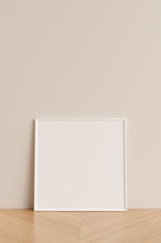 Clean and minimalist front view square white photo or poster frame mockup leaning against wall on wooden floor. 3d rendering.