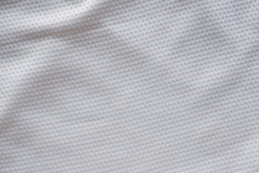 White fabric sport clothing football jersey with air mesh texture background photo