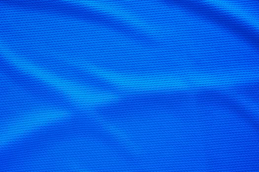 Blue football jersey clothing fabric texture sports wear background, close up top view photo