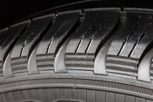 Old worn black tire with many large cracks in the car wheel. photo