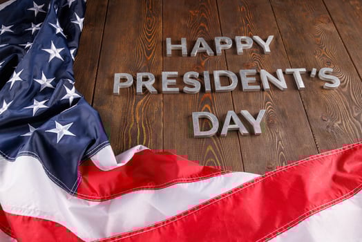 words happy presitdents day laid with real letters on wooden board near US flag photo
