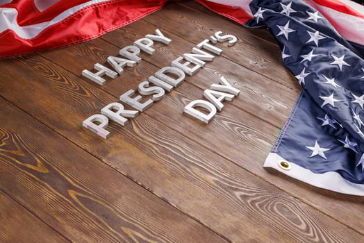 words happy presitdents day laid with real letters on wooden board near US flag photo