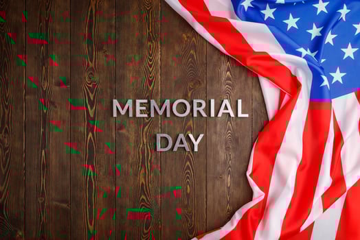 the words memorial day laid with silver metal letters on wooden board surface with crumpled usa flag photo