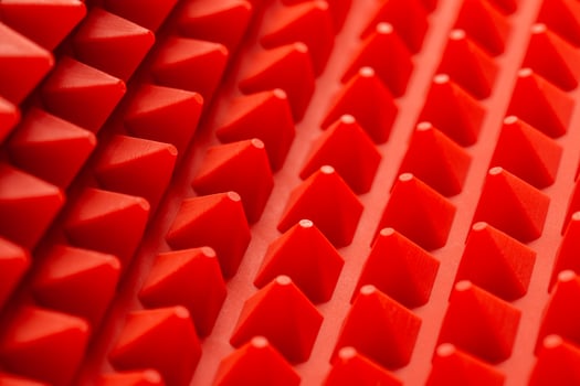 abstract red silicone pyramids mat close-up background photo