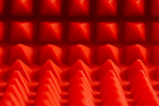 abstract red silicone pyramids mat close-up background photo