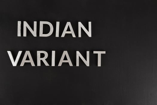 words indian variant laid with silver metal letters on flat matte black surface photo