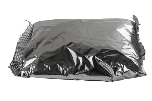 small blank single-use crumpled aluminum foiled plastic bag isolated on white background photo