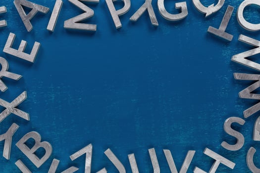 Frame mockup made of of silver metal english alphabet characters on classic blue background. photo
