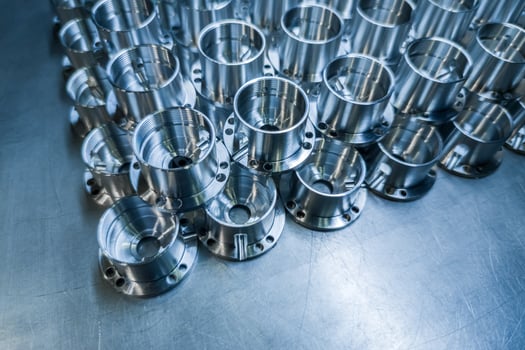 Shiny metal aerospace parts after cnc machining on steel surface with selective focus, industrial background photo