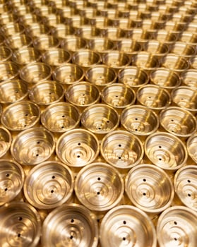 industrial close-up background of shiny brass metal threaded hexagonal parts photo