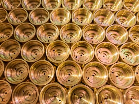 abstract industrial background of shiny brass metal threaded hexagonal parts photo
