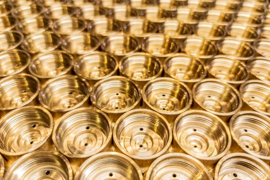 industrial close-up background of shiny brass metal threaded hexagonal parts photo