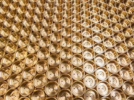 abstract industrial background of shiny brass metal threaded hexagonal parts photo