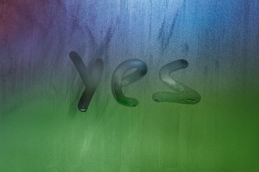 word yes handwritten on foggy window glass surface photo