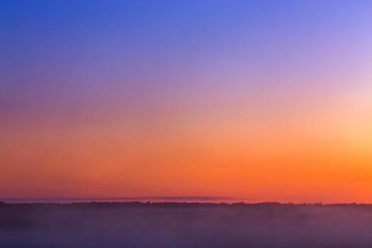 minmalistic foggy sky glow before sunrise without sun photo