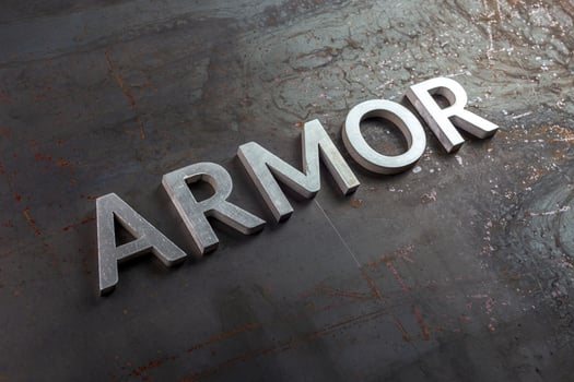 the word armor laid with silver metal letters on rusted iron flat surface background photo