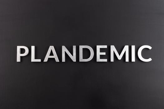 the word plandemic laid with silver letters on flat black background in directly above composition at center of picture photo