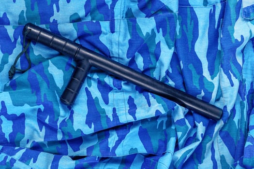 black rubber baton on blue urban russian riot police camouflage flat lay photo