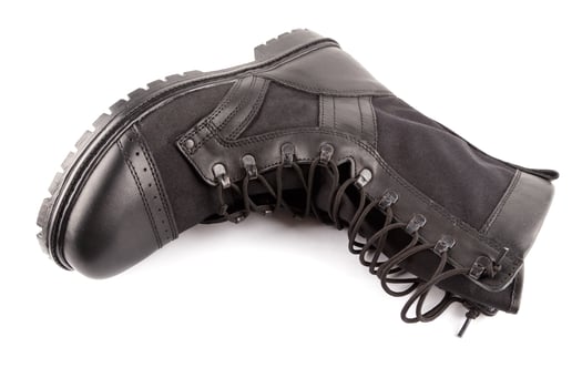 new black lightweight military boot isolated on white background, lying on side photo