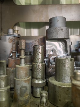 A lot of old rusted machining stock holders dark industrial back photo
