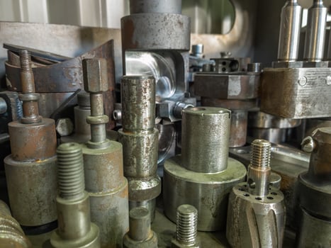 A lot of old rusted machining stock holders dark industrial back photo