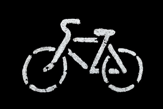 bicycle sign on asphalt with old white paint - isolated on black background photo