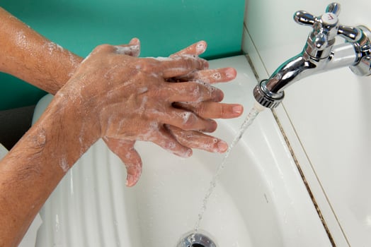 person sanitizing hands photo