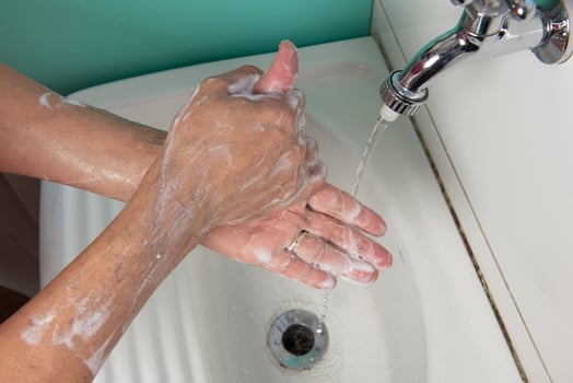 person sanitizing hands photo