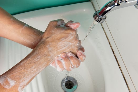 person sanitizing hands photo