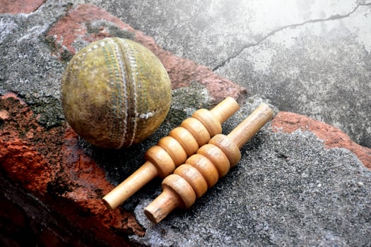 Cricket sport equipments on brick, bat, wicket, old leather ball, soft and selective focus. photo
