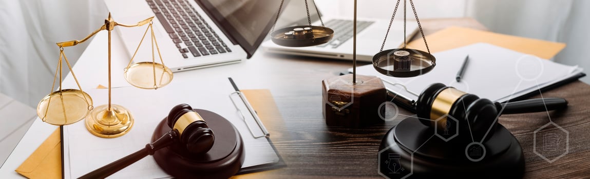 Justice and law concept.Male judge in a courtroom with the gavel, working with, computer and docking keyboard, eyeglasses, on table in morning light photo