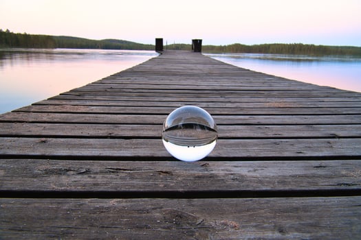 Glass ball on a wooden pier at a Swedish lake at evening hour. Nature Scandinavia photo